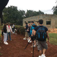 <p>Students conduct an interview on a Cuban farm.</p>