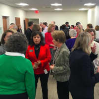 <p>Ridgefield Visiting Nurse Association President and CEO Theresa Santoro, center in red coat, speaks with a group of people prior to the official opening of the RVNA&#x27;s new facility Friday.</p>