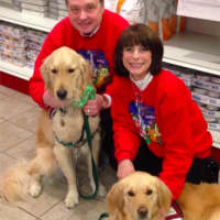 <p>Michele and Tom Meli of Hasbrouck Heights with their dogs, Axel and Liberty.</p>