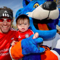 <p>A family at the STAR Walk, 5K Run &amp; Roll with STORM of the Sound Tigers.</p>