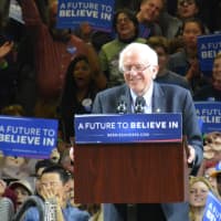 <p>Bernie Sanders smiles while addressing a large crowd at Marist College.</p>
