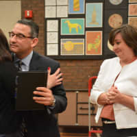 <p>Dr. Christopher Manno hugs his wife, Melissa, moments after Bedford Central&#x27;s school board appointed him as schools superintendent. School Board President Jennifer Gerken, pictured at right, looks on.</p>