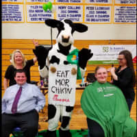 <p>Two team members from Chick-Fil-A shave their heads to show support for childhood cancer research at Brookfield High School&#x27;s Peer Counselor fundraiser.</p>