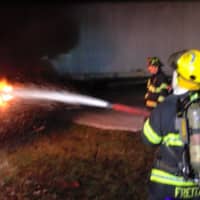 <p>Fire Department members putting out a fire as part of their drill</p>