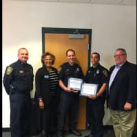 <p>From left, Chief Thomas Kulhawik, Commissioner Fran Collier-Clemmons, Officers Brendan Collins and Daniel Vazquez and Commissioner Charles Yost. Collins and Vazquez were honored for saving the life of a car crash victim.</p>