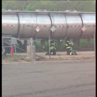 <p>Greenwich firefighters work to repair a leaking tanker.</p>