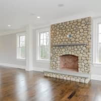 <p>The home includes a gorgeous stone fireplace.</p>