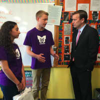<p>Wilson Brawley, an eighth-grader at New Fairfield Middle School, explains the Wingman program at the school to U.S. Sen. Chris Murphy, as Isabella Scampone looks on.</p>