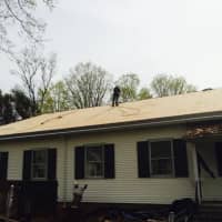 <p>Workers for KRS Roofing install the new roof.</p>