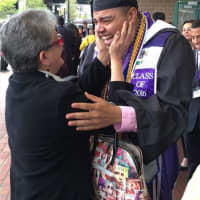 <p>A University of Bridgeport graduate hugs his mom after the commencement ceremony on Saturday at the Webster Bank Arena.</p>
