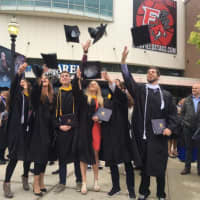 <p>Graduates celebrate Saturday after the commencement exercises for the University of Bridgeport at Webster Bank Arena.</p>