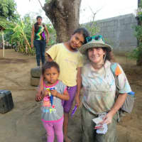 <p>Diana Sarna making friends with some children in Nicaragua, whose home she helped to build.</p>