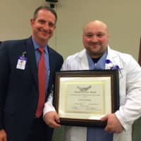 <p>Frank Dechane, coordinator of the Sterile Processing Department and winner of the “Partner in Care Award” with Marc Kosak, senior vice president of administration.</p>