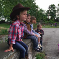 <p>Grace O&#x27;Sullivan, in cowboy hat, and other friends from the Round Hill Nursery School wait for a ride on a pony during Western Day at the school Friday.</p>
