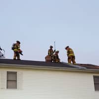 <p>Members of Shelton Fire Companies train on the roof of a demo house.</p>