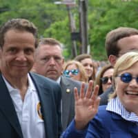 <p>Chappaqua&#x27;s Hillary Clinton waves as she marches in New Castle&#x27;s Memorial Day parade. Gov. Andrew Cuomo, who lives in the northern side of town, is pictured at left.</p>