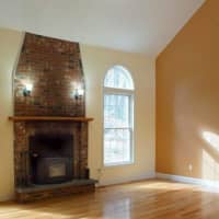 <p>A magnificent fireplace anchors the living room.</p>