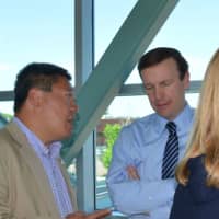 <p>State Sen. Tony Hwang talks with U.S. Sen. Chris Murphy about the potential of the Fairfield Metro train station and the surrounding area.</p>