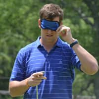 <p>Eli Manning puts on a blindfold to prepare for a blindfolded putting attempt at the Mount Kisco Country Club. Manning visited the club on Monday for his annual appearance at Guiding Eyes for the Blind&#x27;s fundraiser.</p>