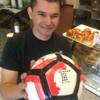 <p>Sal Reina holds the 2016 Coppa Francesca ball in his Glen Rock shop.</p>