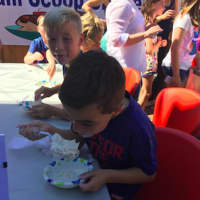 <p>Dr. Rebecca Timlin-Scalera&#x27;s son Luca happily tries to eat as much ice cream he can at an event Friday in Fairfield to raise money for breast cancer research.</p>