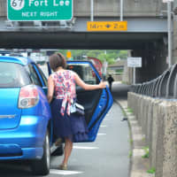 <p>A woman gets into a car for a ride across the bridge.</p>