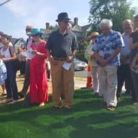 <p>About 100 people gather at City Hall on Monday to watch the unveiling of the Hatters&#x27; Monument.</p>