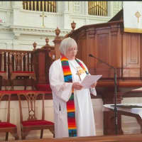 <p>The Rev. Pat Kriss, Pastor of the First Congregational Church of Danbury, gives a welcome and invocation at the Interfaith Vigil for the victims of the Orlando shooting.</p>