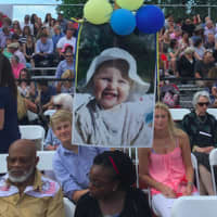 <p>Henrik Akerman, 14, holds a baby photograph of his sister Camilla who was graduating Tuesday at Greenwich High School&#x27;s 147th commencement.</p>
