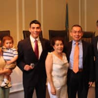 <p>At the City Hall swearing-in ceremony are new Rye Police Officer Christopher Salguero (center), his sister, Stephanie; her son, Dominic; his parents, Nancy and Carlos Salguero; and Rye Police Commissioner Michael C. Corcoran, far right.</p>