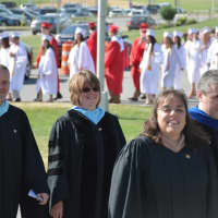 <p>Somers school officials lead a long line of graduates to the 2016 commencement.</p>