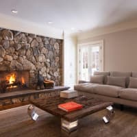 <p>The family room boats a beautiful stone fireplace.</p>