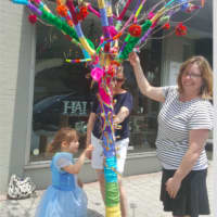 <p>Avery Friedland, left, along with her mother Meghan Friedland and Toy Room owner Kim Ramsey examine the tree that was decorated to honor the victims of the Orlando shooting.</p>