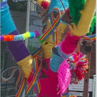 <p>Yarn, rainbow ribbons and pom-poms adorn a tree on Greenwood Avenue in Bethel in honor of the Orlando tragedy victims.</p>