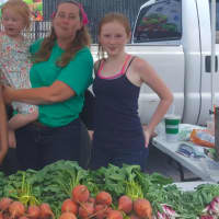 <p>Vendor Willow Schulz, owner of Clatter Valley Farm in New Milford, along with her two daughters.</p>