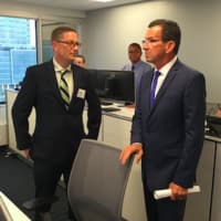 <p>Mike Maxwell, left, chief security officer with CYBERshark in Stamford speaks with Gov. Dannel P. Malloy at the company&#x27;s official opening in Stamford on Tuesday.</p>