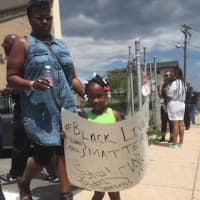 <p>A young protestor holds a sign during the Black Lives Matter march on police headquarters in Bridgeport Sunday to protest police shootings.</p>