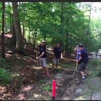 <p>Workers help to clean up the property at Camp Candlewood off Bogus Hill Road in New Fairfield.</p>