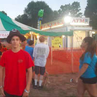 <p>15-year-old Alek Sey wearing a poop emoji hat he won at New Fairfield&#x27;s Olde Tyme Carnival</p>
