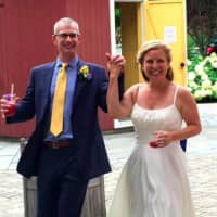 <p>Jenn and Dan Balliett smile at their wedding reception. The Norwalk couple, who married on July 16, met at a Little League baseball practice three years ago.</p>