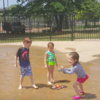 <p>Kids have fun playing in the water at the Rogers Park sprayscape in Danbury. From left, Cameron DeMato, Jemma DeMato and Emily Frascione.</p>
