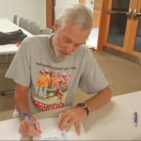 <p>Boston Marathon winner Amby Burfoot was signing his books for fans at the Ridgefield Library.</p>
