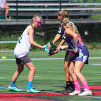<p>An X-Treme Lax Factory athlete, left, faces an opponent at a June tournament.</p>
