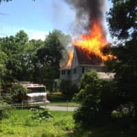 <p>A fire roars through a home on Carolyn Place in Chappaqua in 2013. P. Morrissey Contracting in Mt. Kisco won a Pinnacle Award for its work in rebuilding the home.</p>
