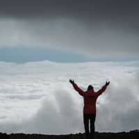 <p>Alicia O&#x27;Neill of Norwalk looks out after reaching the summit at Mount Kilimanjaro.</p>