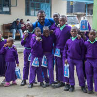 <p>Dr. Alain Auguste meets boys in Tanzania, where he spent four days helping residents there with dental needs. Auguste works for Aspen Dental in Fairfield.</p>