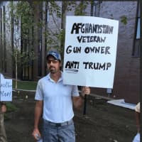 <p>This protester just got off the golf course and headed to the Love Trumps Hate rally on Saturday afternoon at Sacred Heart University. That&#x27;s a golf club holding up his sign. The protest was held before the start of a Donald Trump campaign rally.</p>