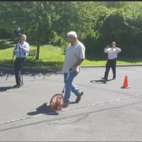 <p>Surveyors from Luchs Consulting Engineers in Meriden measure the friendship bracelet to see if it broke the current world record.</p>