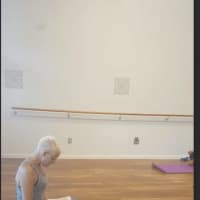 <p>An instructor reads from the Bible at Holy Yoga in New Fairfield</p>