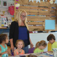 <p>Owner Hannah Perry laughs with some of the summer campers at The Giggling Pig in Shelton.</p>
